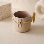 Raised twisted barbed-wire relief on a blush-beige ceramic mug