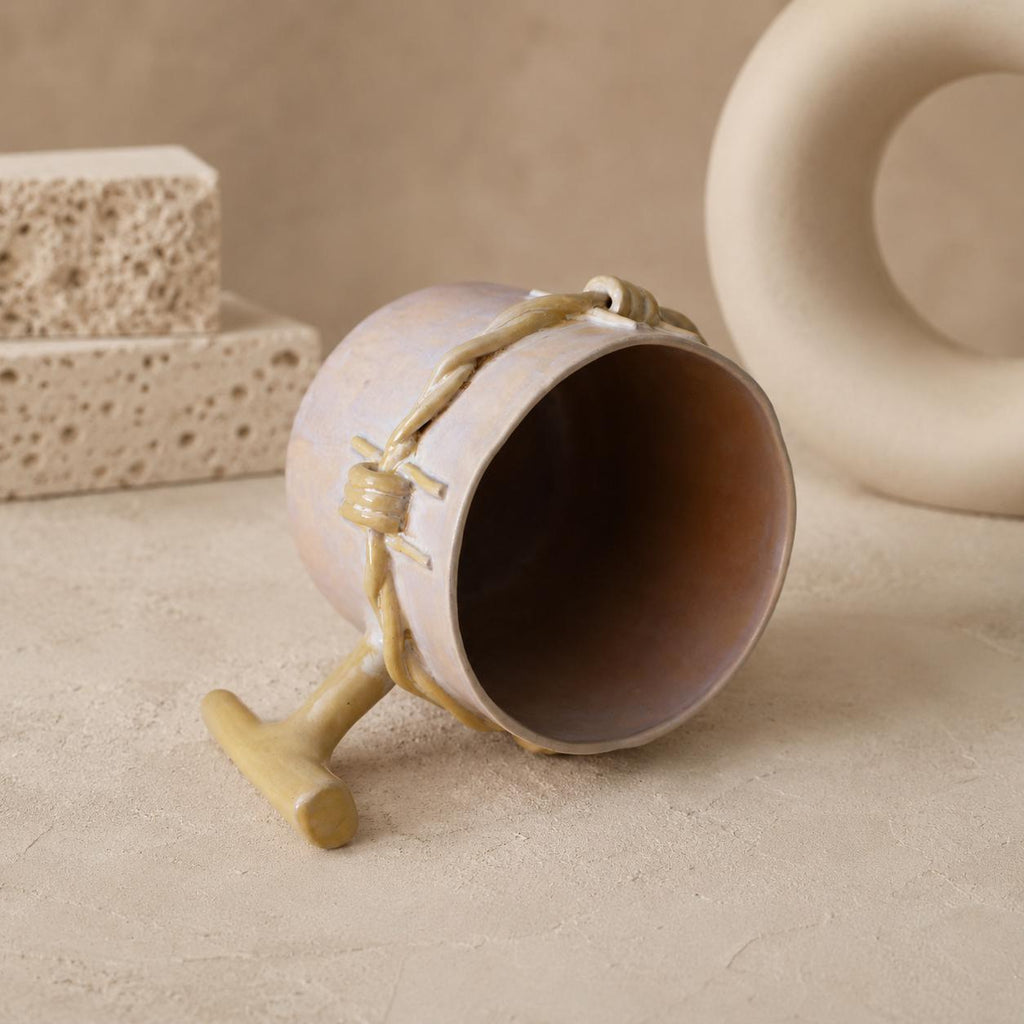 Close-up of barbed-wire texture on a handmade mug