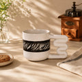 Black brushstroke porcelain mug with sculptural loop handle by HUE Atelier