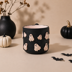 Soft pink interior of a black ghost coffee mug