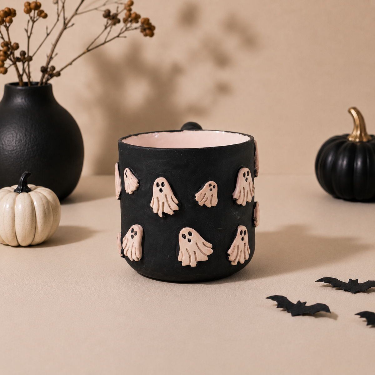 Soft pink interior of a black ghost coffee mug