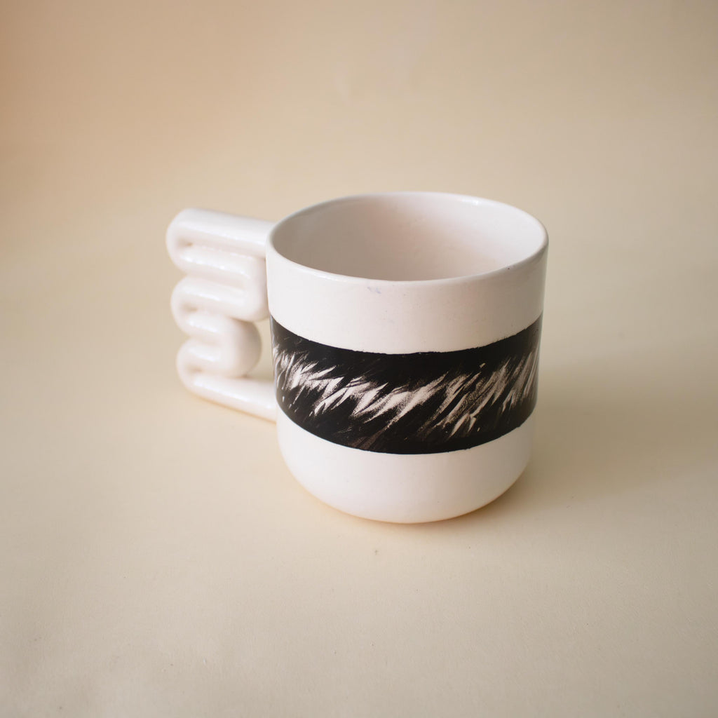 Glossy white mug with flowing black abstract brushwork