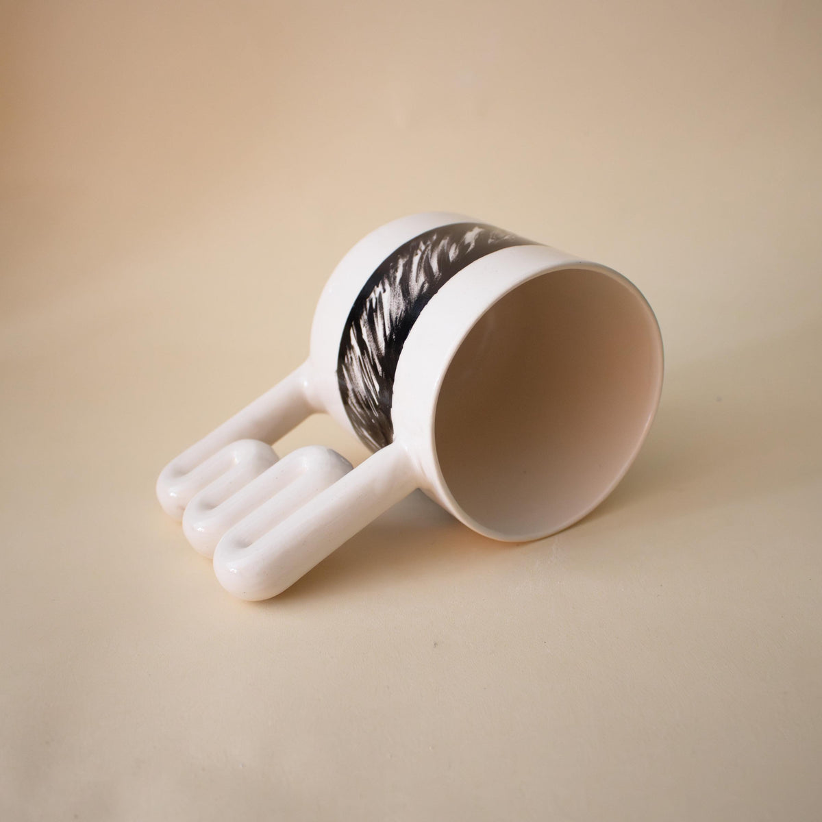 Close-up of hand-painted black lines on porcelain
