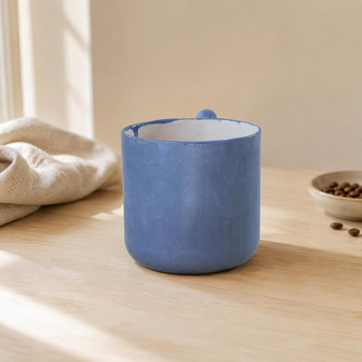 Light interior with blue rim accents on a handmade mug