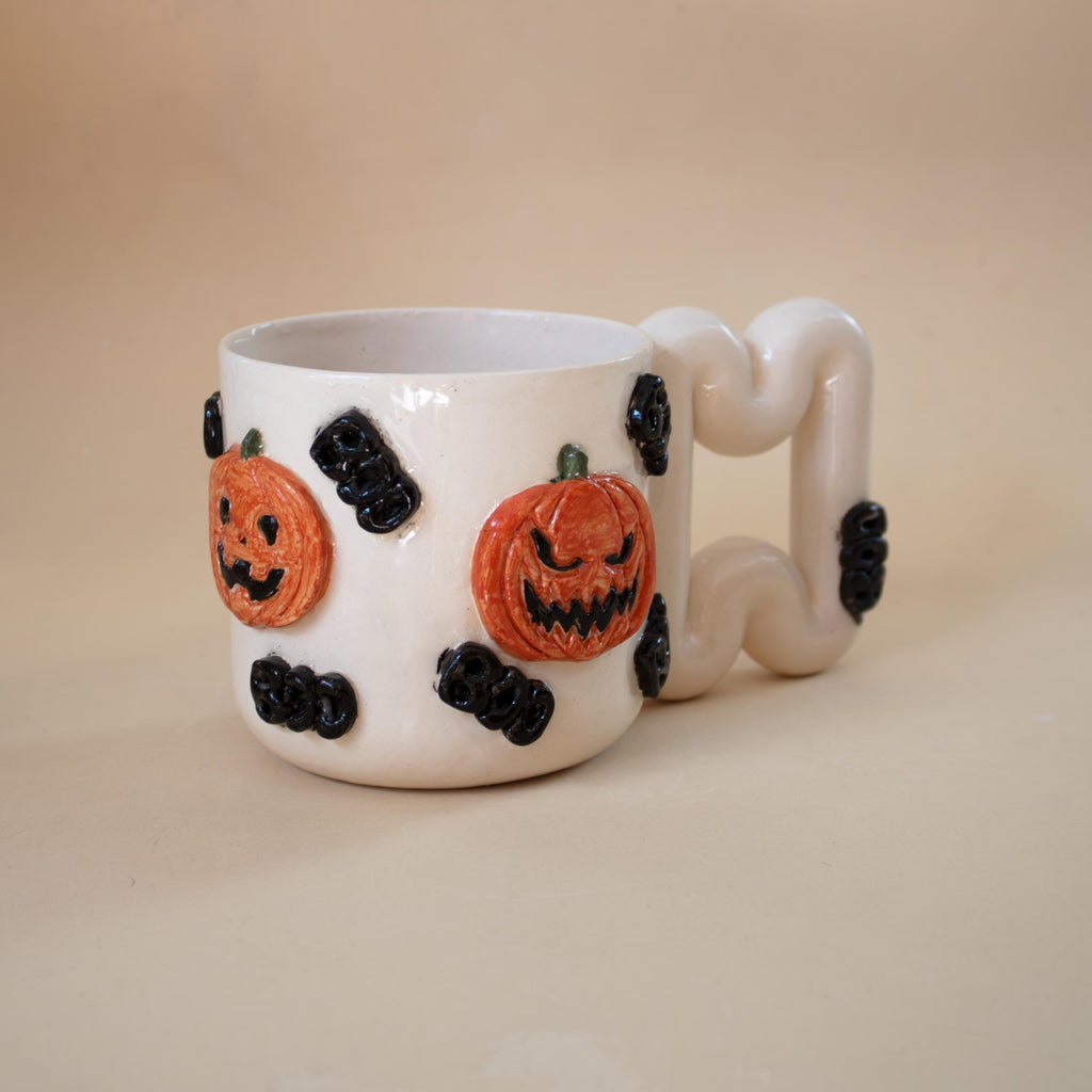 White porcelain Halloween mug covered in orange 3D pumpkins