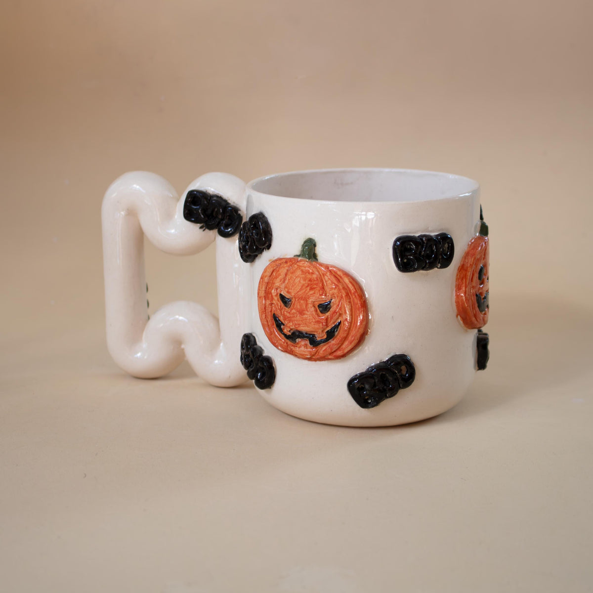 Zigzag sculptural handle on a Halloween porcelain cup