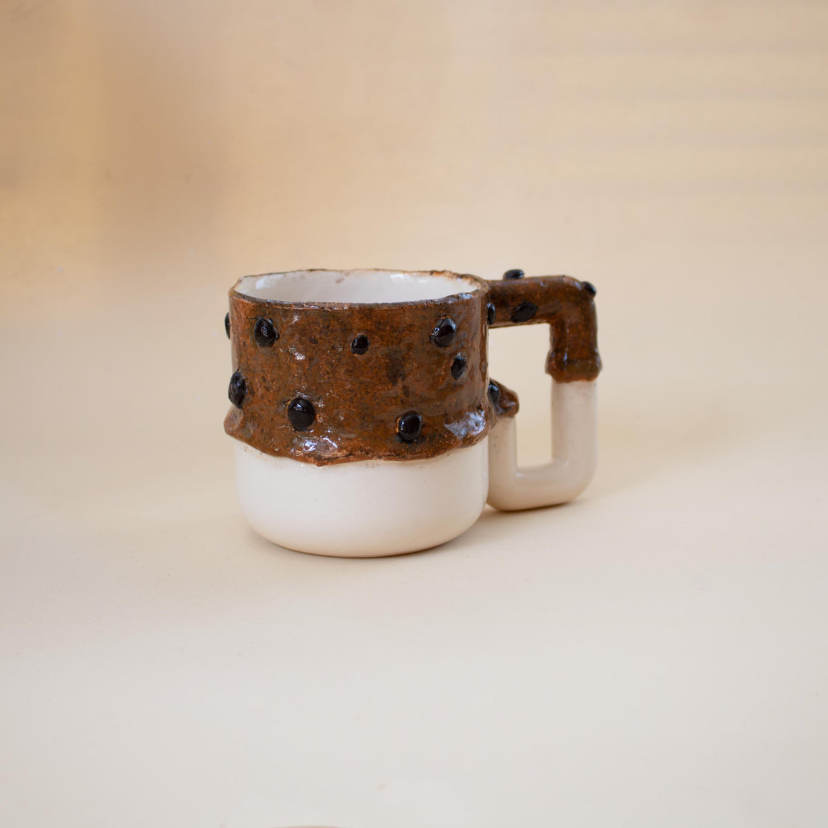 Deep brown textured glaze with glossy black chips