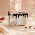 Handmade chocolate drip porcelain mug with red rose handle by HUE Atelier