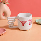 Stacked sculptural loop handle on an illustrated mug