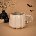 Oversized cream pumpkin stoneware mug with twisted vine handle by HUE Atelier