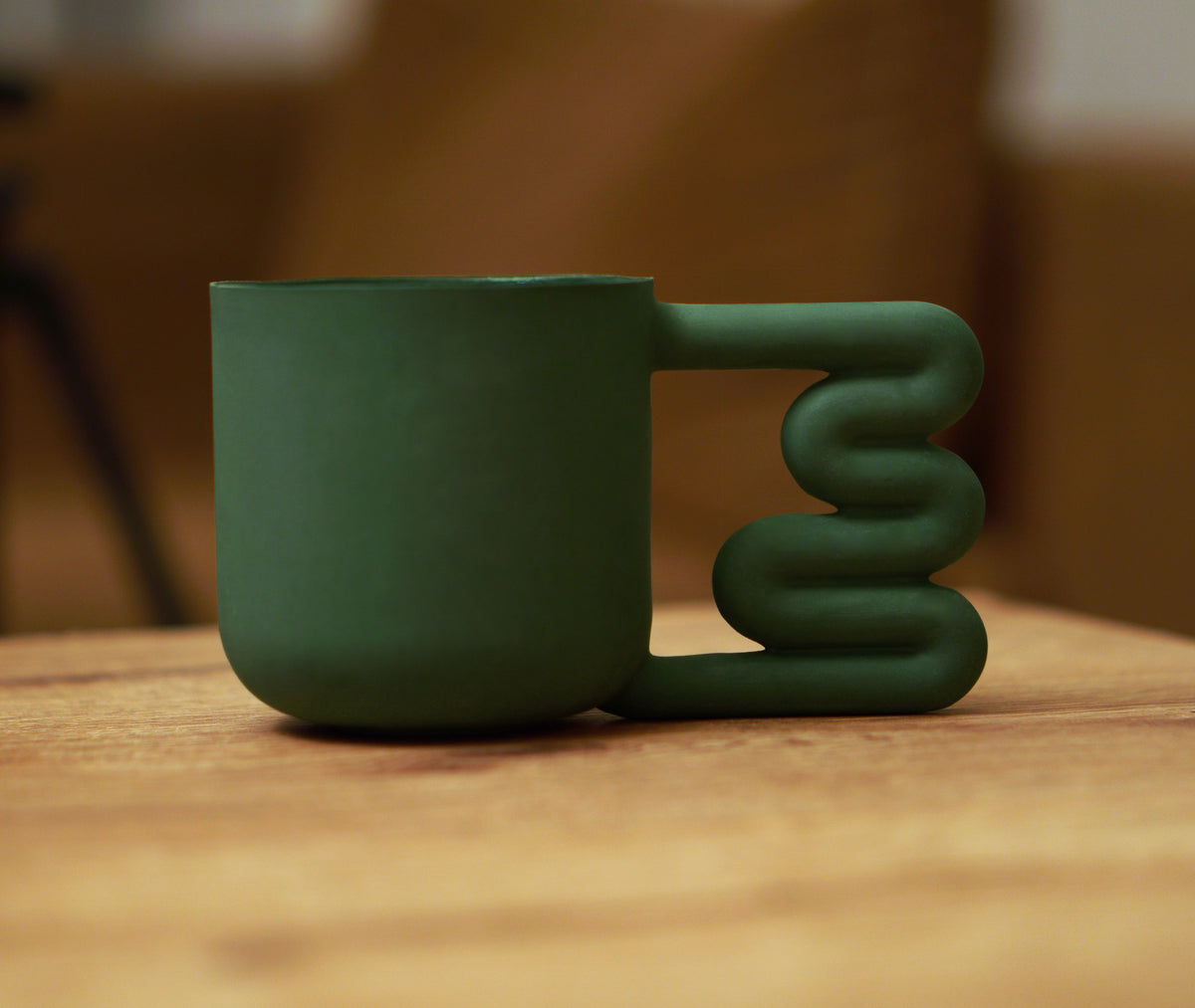 Earthy green mug on a kitchen shelf