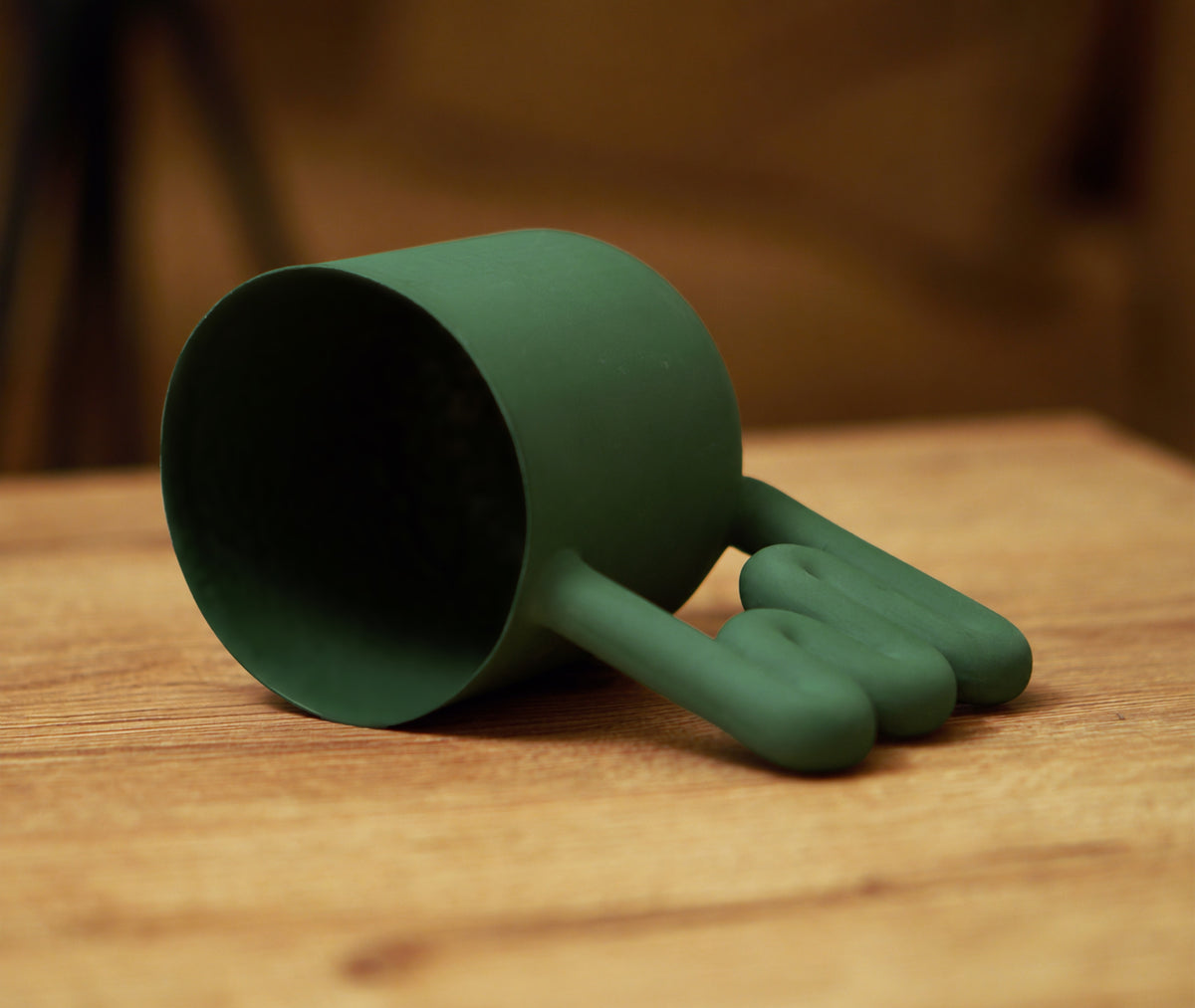 Green porcelain cup styled with natural textures
