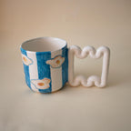 Hand-painted egg and blue stripes porcelain mug by HUE Atelier