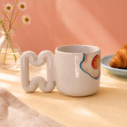Wavy handle on a breakfast themed coffee cup