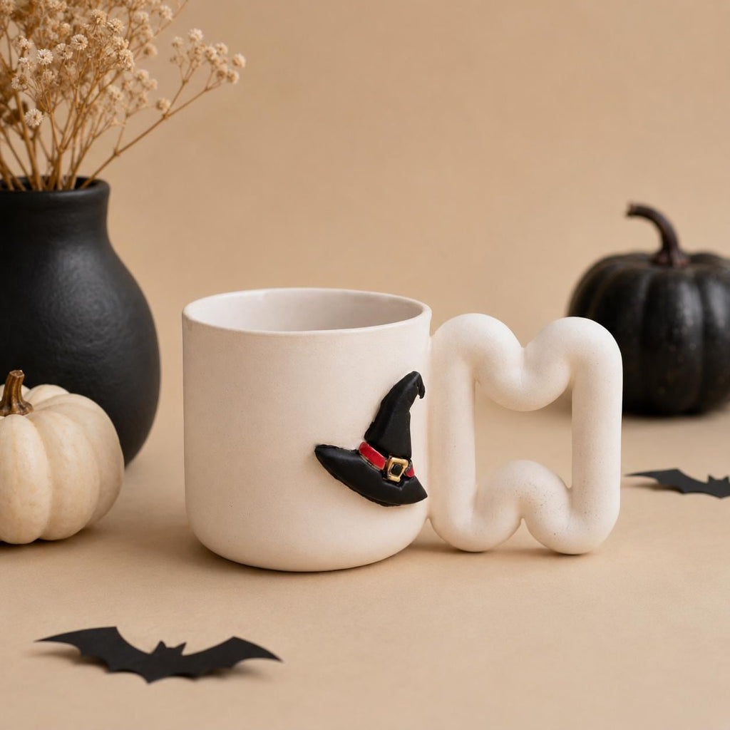 Handmade witch hat and cauldron porcelain mug with sculptural squiggle handle by HUE Atelier