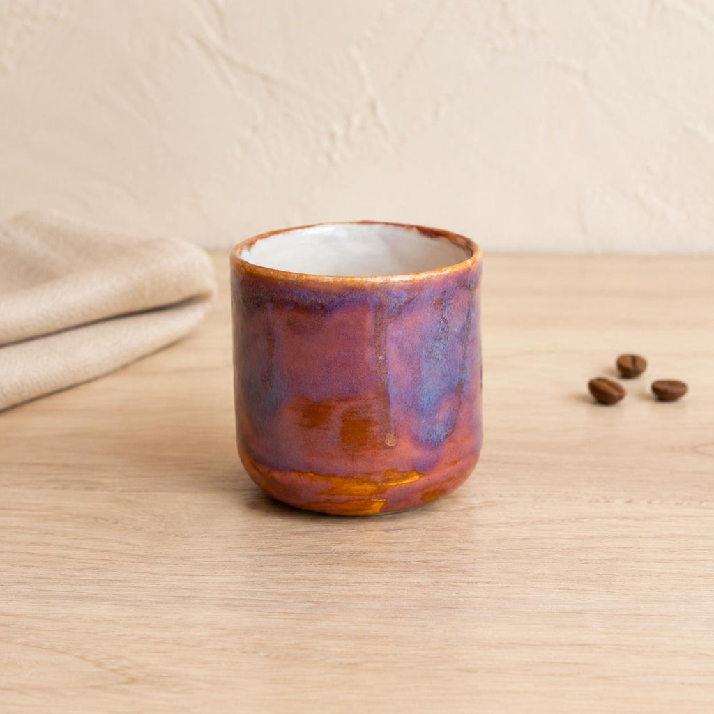 Sculptural squiggle handle on a purple coffee mug