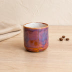 Sculptural squiggle handle on a purple coffee mug
