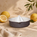 Brown and white manual lemon reamer on a kitchen counter