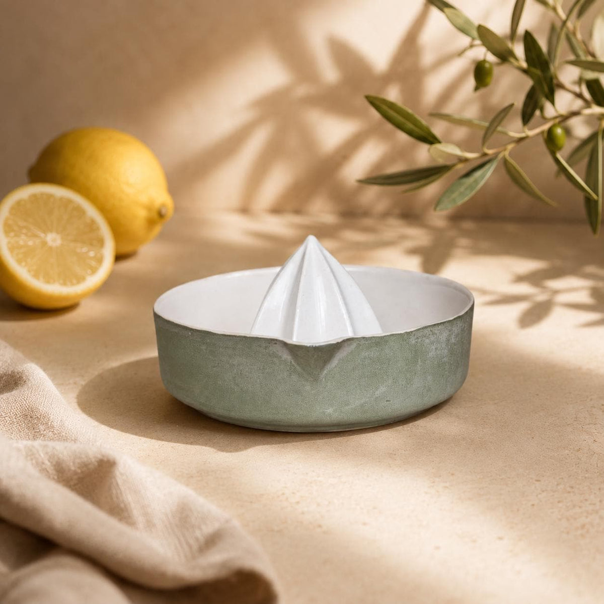 Matte green porcelain citrus juicer with pour spout by HUE Atelier
