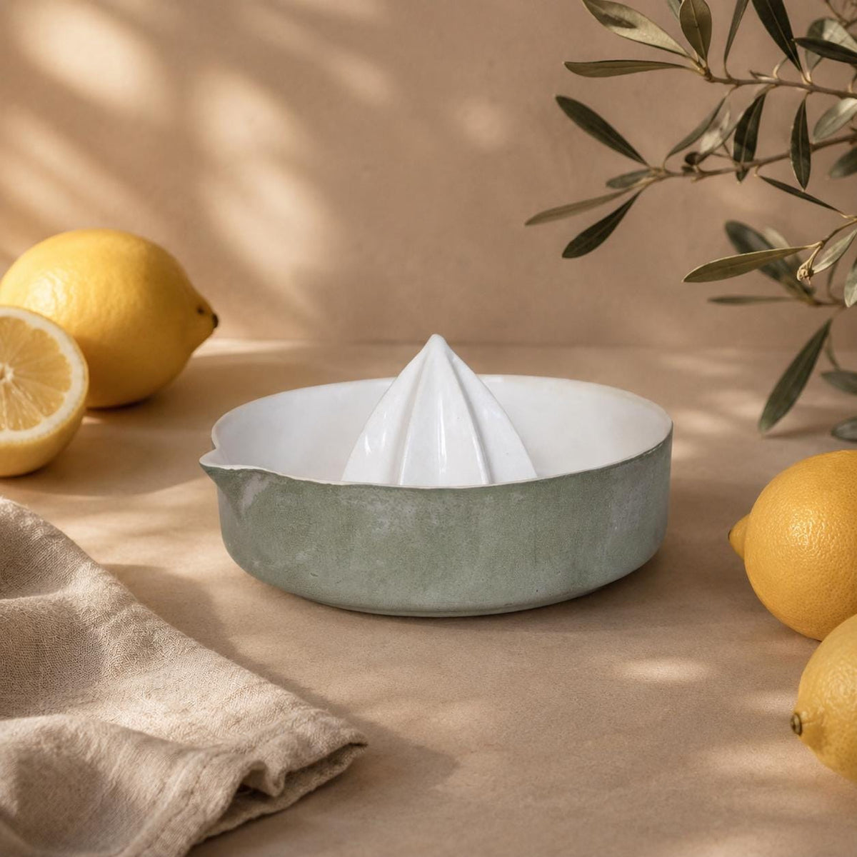 Glossy white ridged reamer in a green lemon squeezer