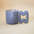 Matte indigo blue porcelain mug with funky handle by HUE Atelier