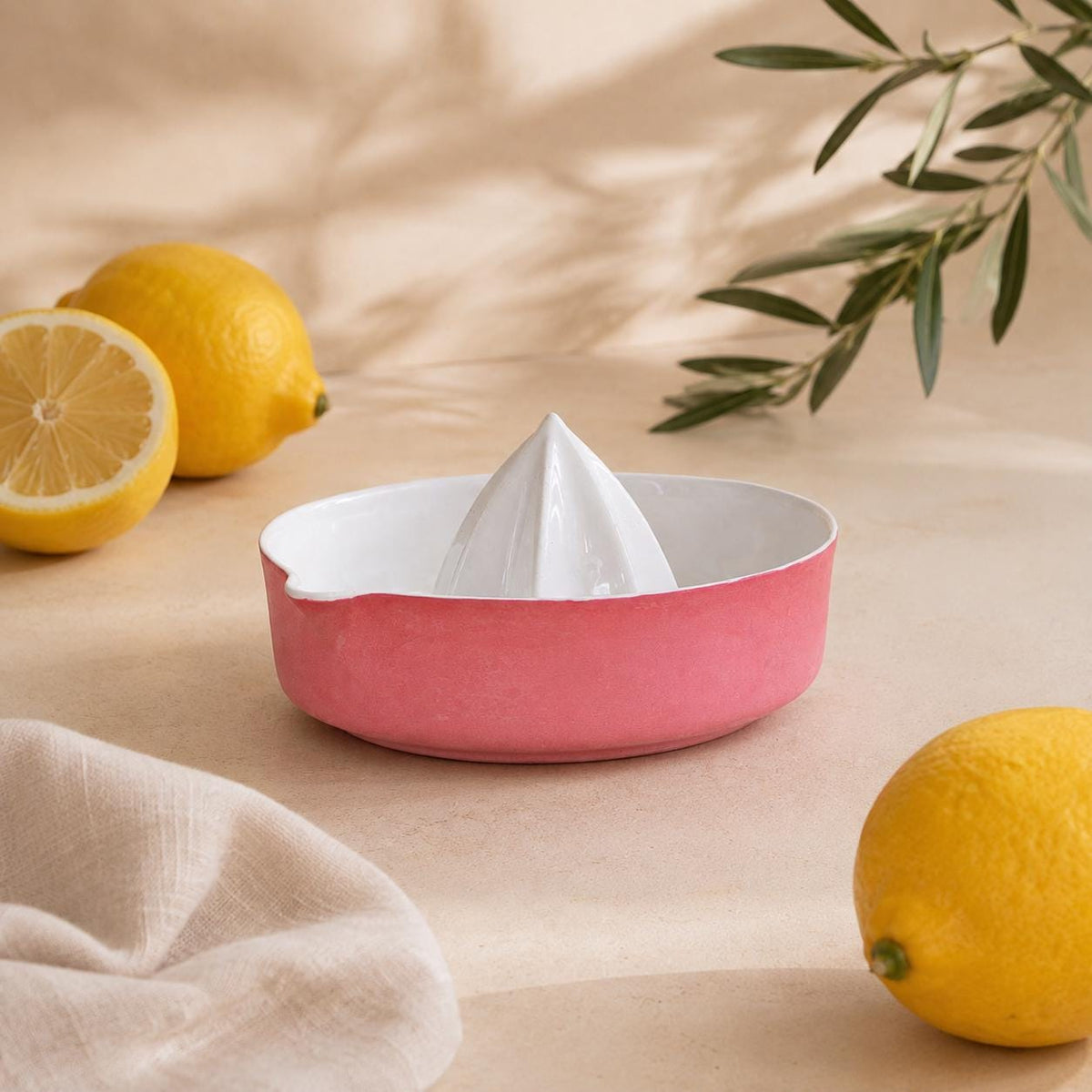 Glossy white faceted reamer inside a red lemon squeezer