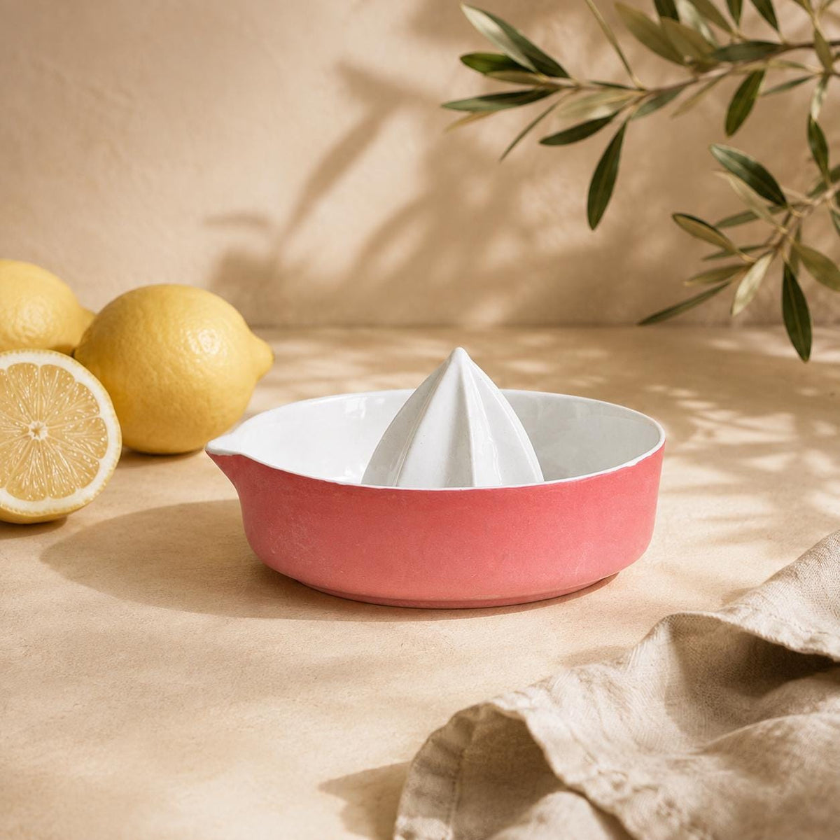 Built-in pour spout on a red citrus juicer