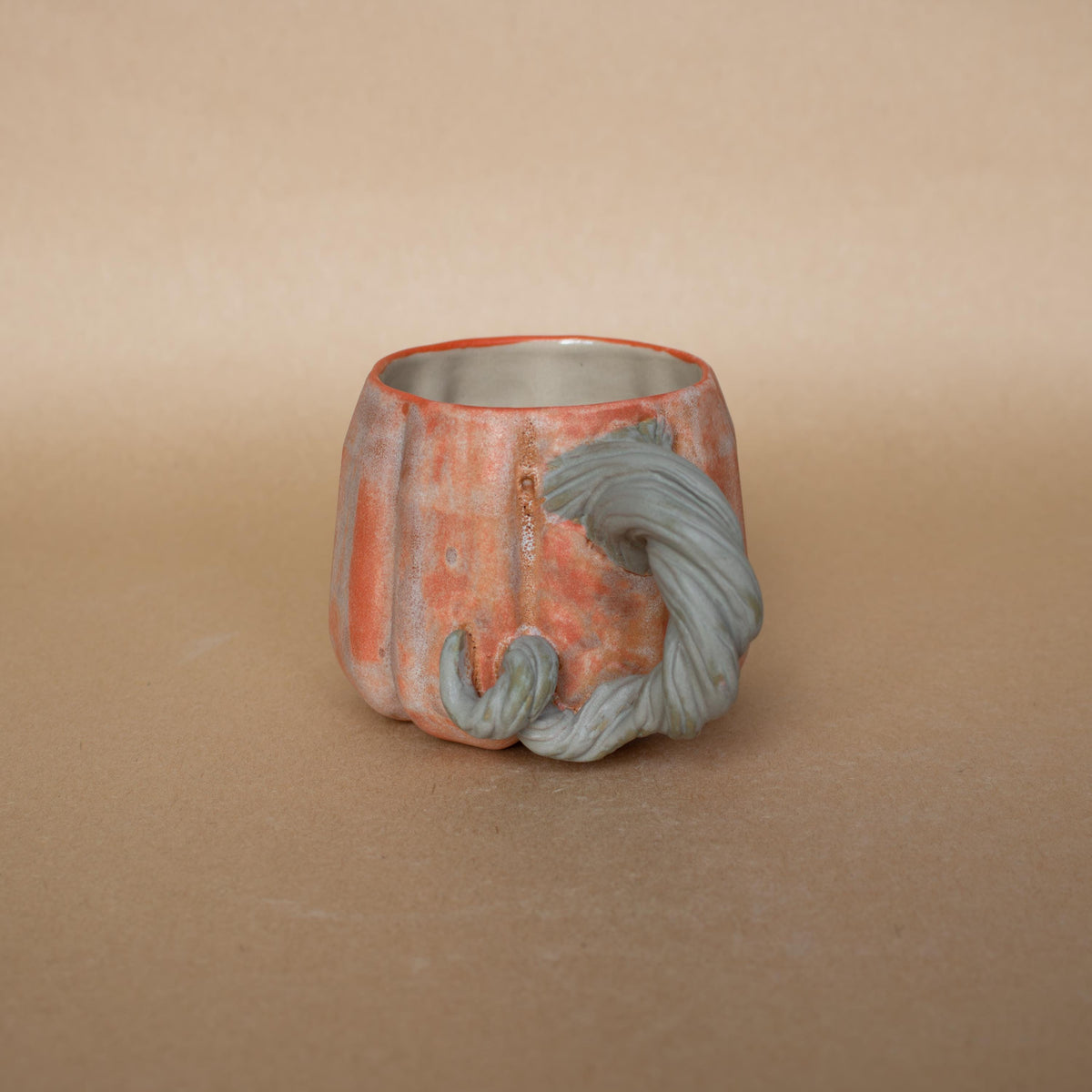 Hand-sculpted vine handle on a mini pumpkin cup