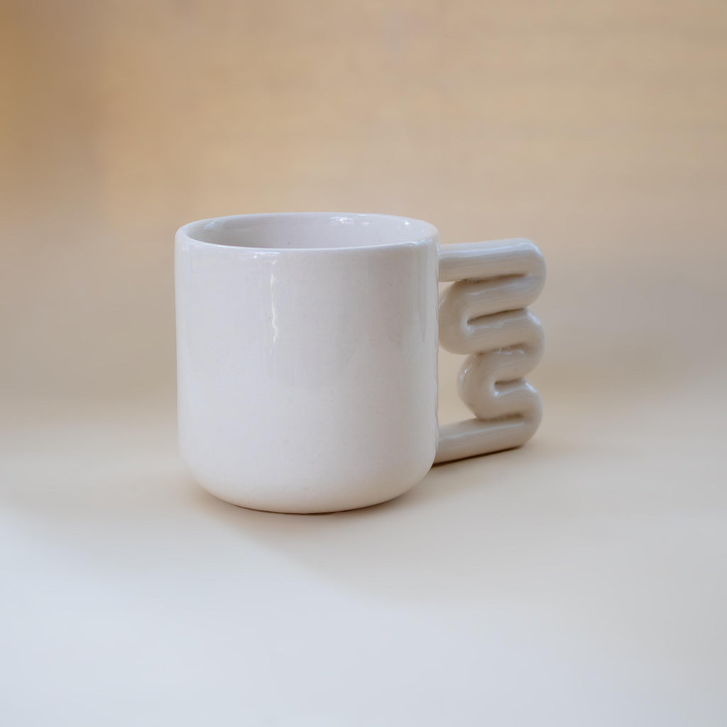 Clean modern coffee mug with sculptural handle