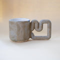 Natural stone speckled porcelain mug with funky handle by HUE Atelier