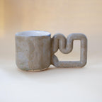 Natural stone speckled porcelain mug with funky handle by HUE Atelier