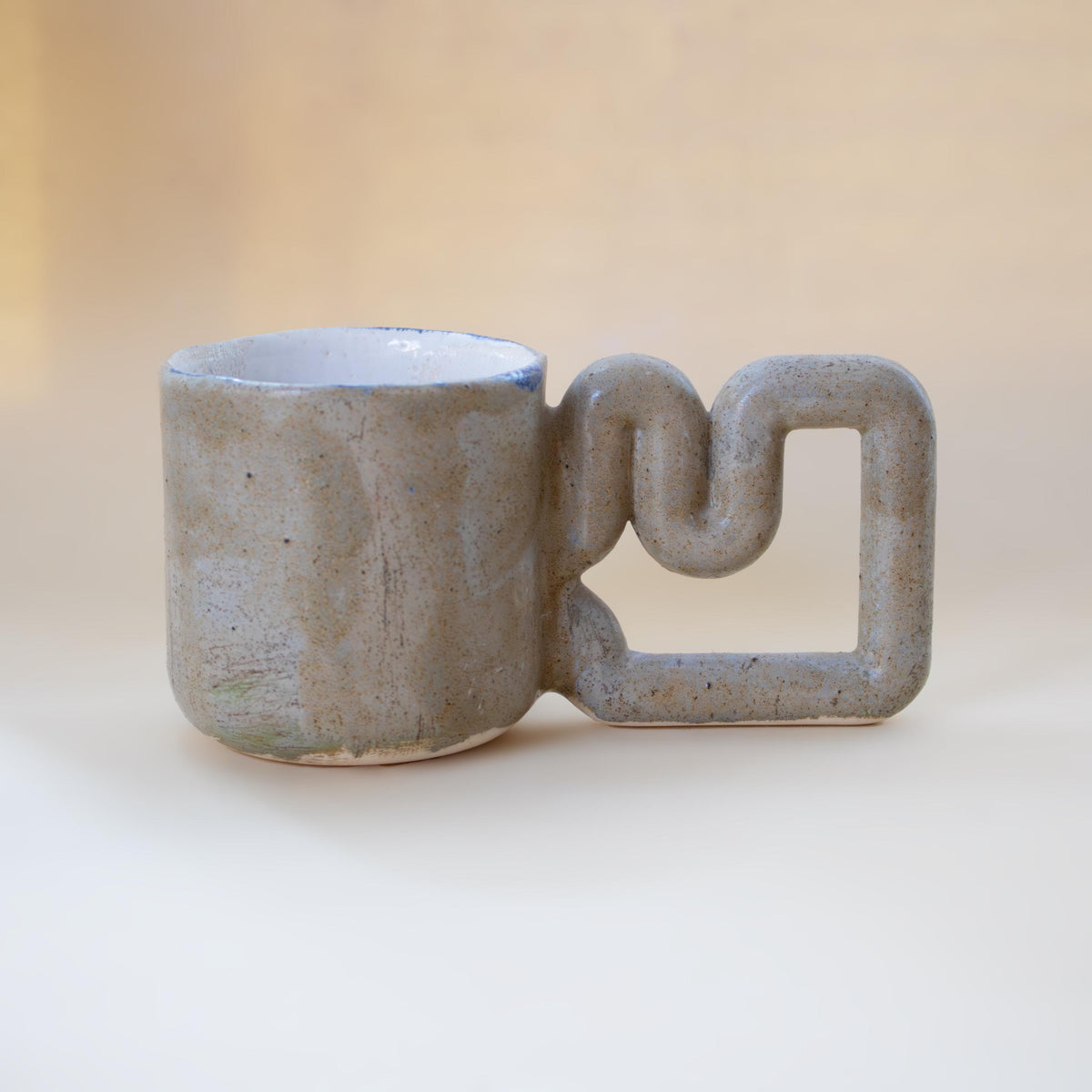 Natural stone speckled porcelain mug with funky handle by HUE Atelier