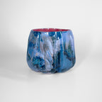 Berry-pink glazed interior of a blue pumpkin mug