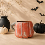 Hand-sculpted grey vine handle on a pumpkin mug