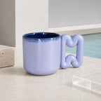 Soft blue coffee mug with deep navy interior