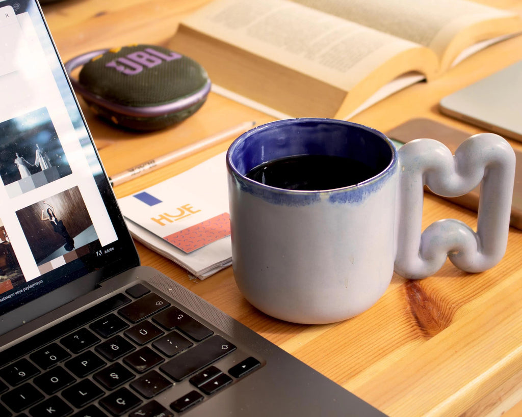 Pastel blue mug on a minimalist coffee station