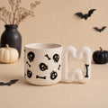 Handmade skull and bones gothic porcelain mug with squiggle handle by HUE Atelier
