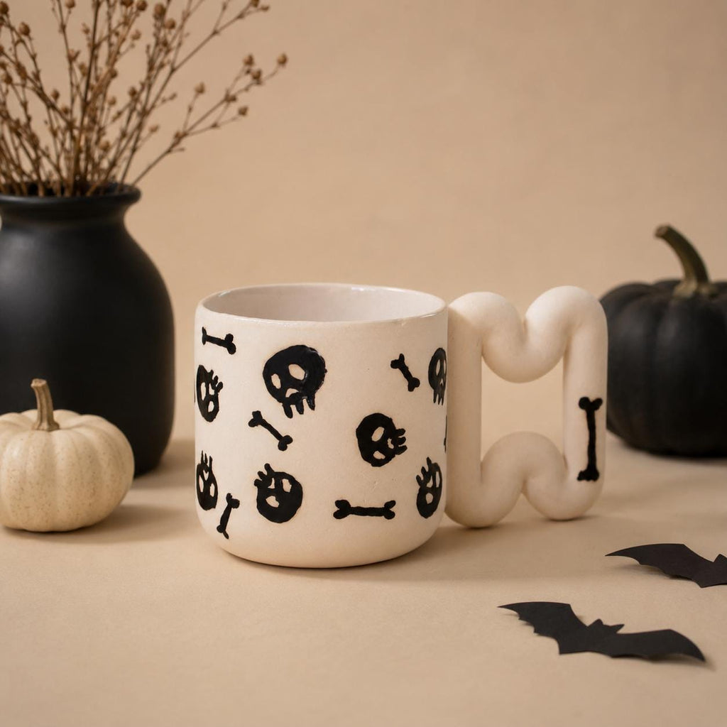 Gothic skull coffee mug in matte white porcelain with glossy black skulls