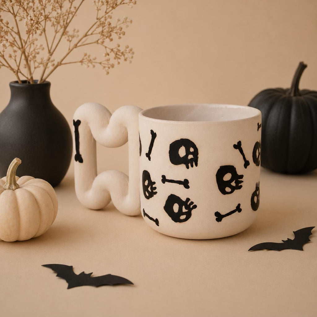 Black skull and crossbones pattern on a handmade porcelain coffee cup