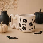 Black skull and crossbones pattern on a handmade porcelain coffee cup