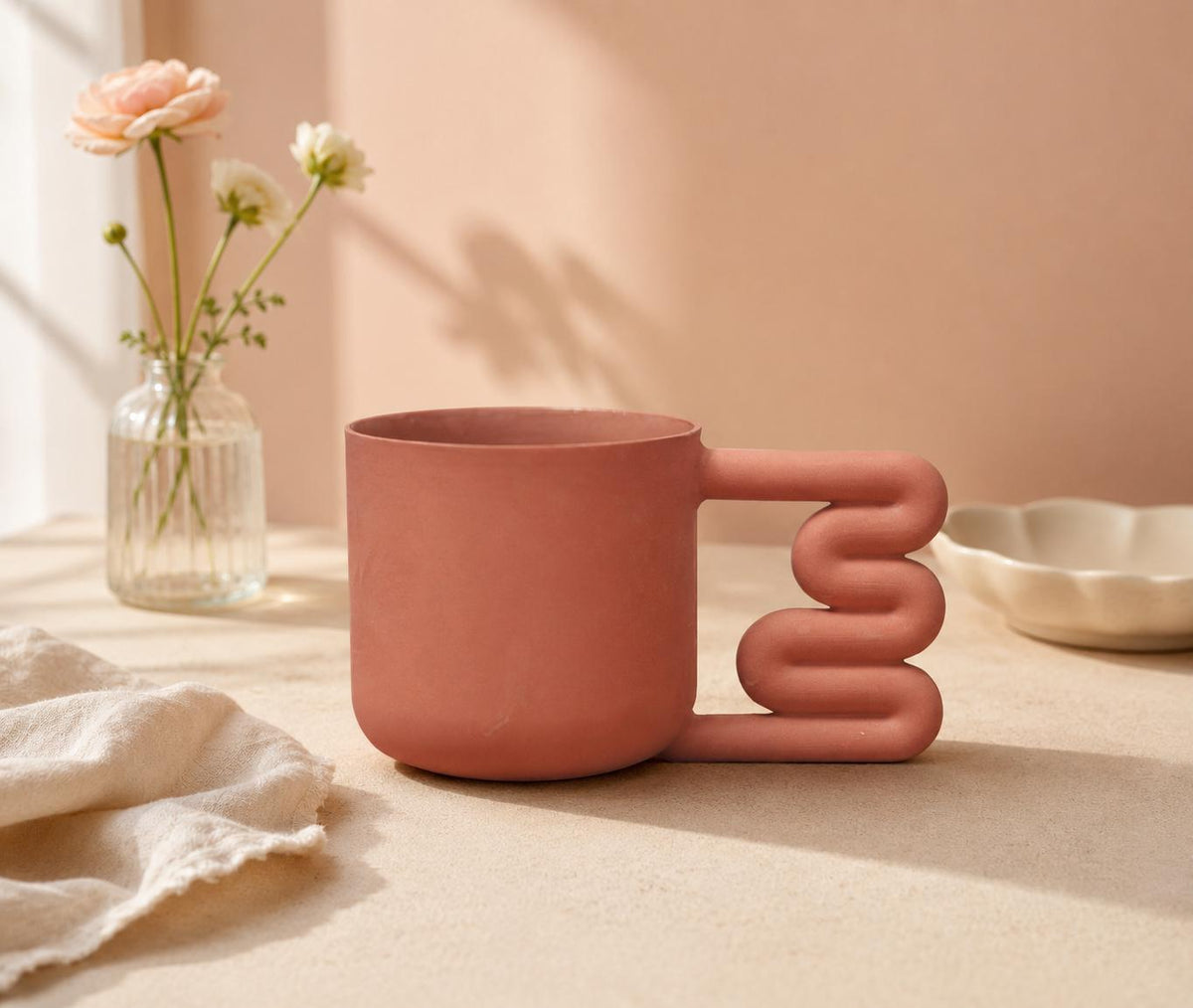 Terracotta coral porcelain mug with squiggle handle by HUE Atelier