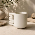 Warm white matte porcelain mug with squiggle handle by HUE Atelier