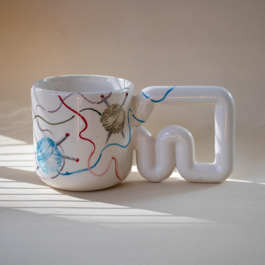 Hand-painted yarn and knitting needle porcelain mug by HUE Atelier