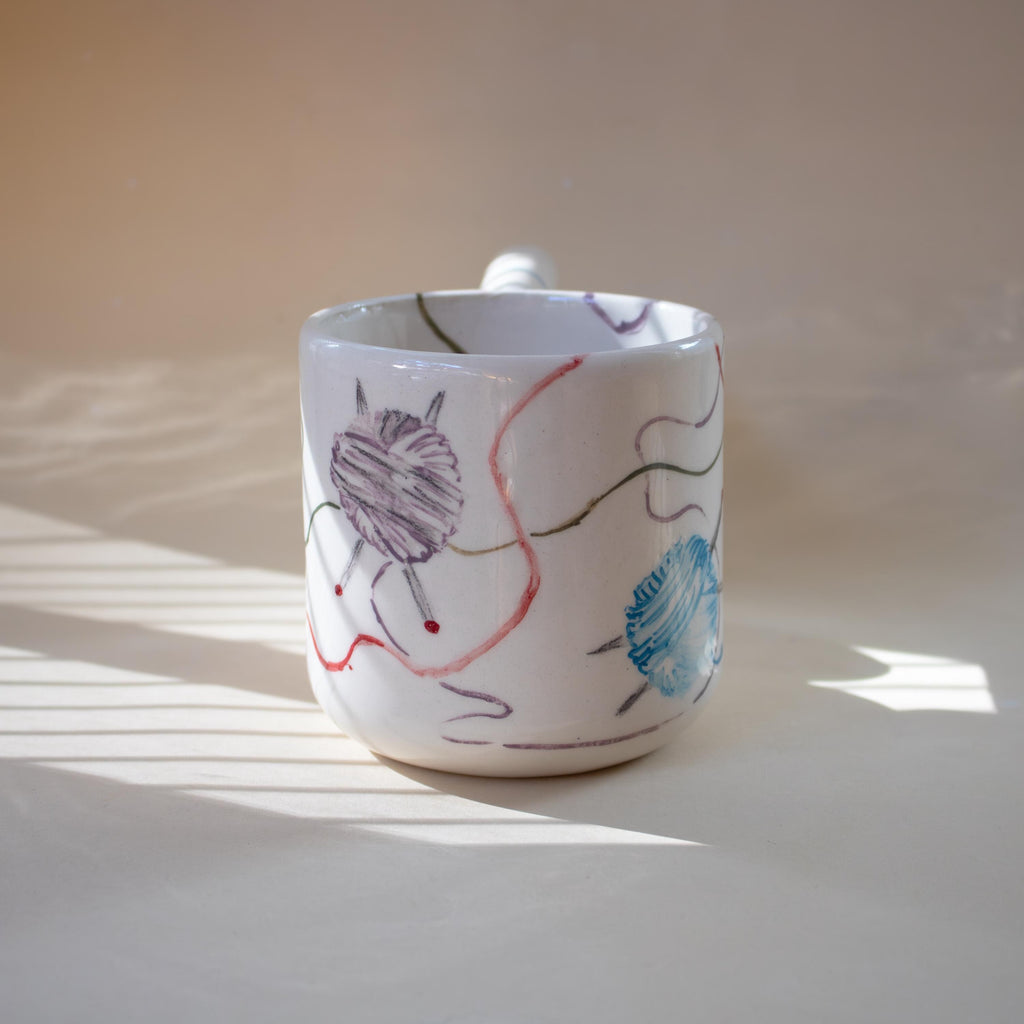 Wavy funky handle on a knitting themed mug