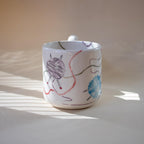 Wavy funky handle on a knitting themed mug